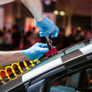 Technician performing a repair on a car Windshield Cracks.